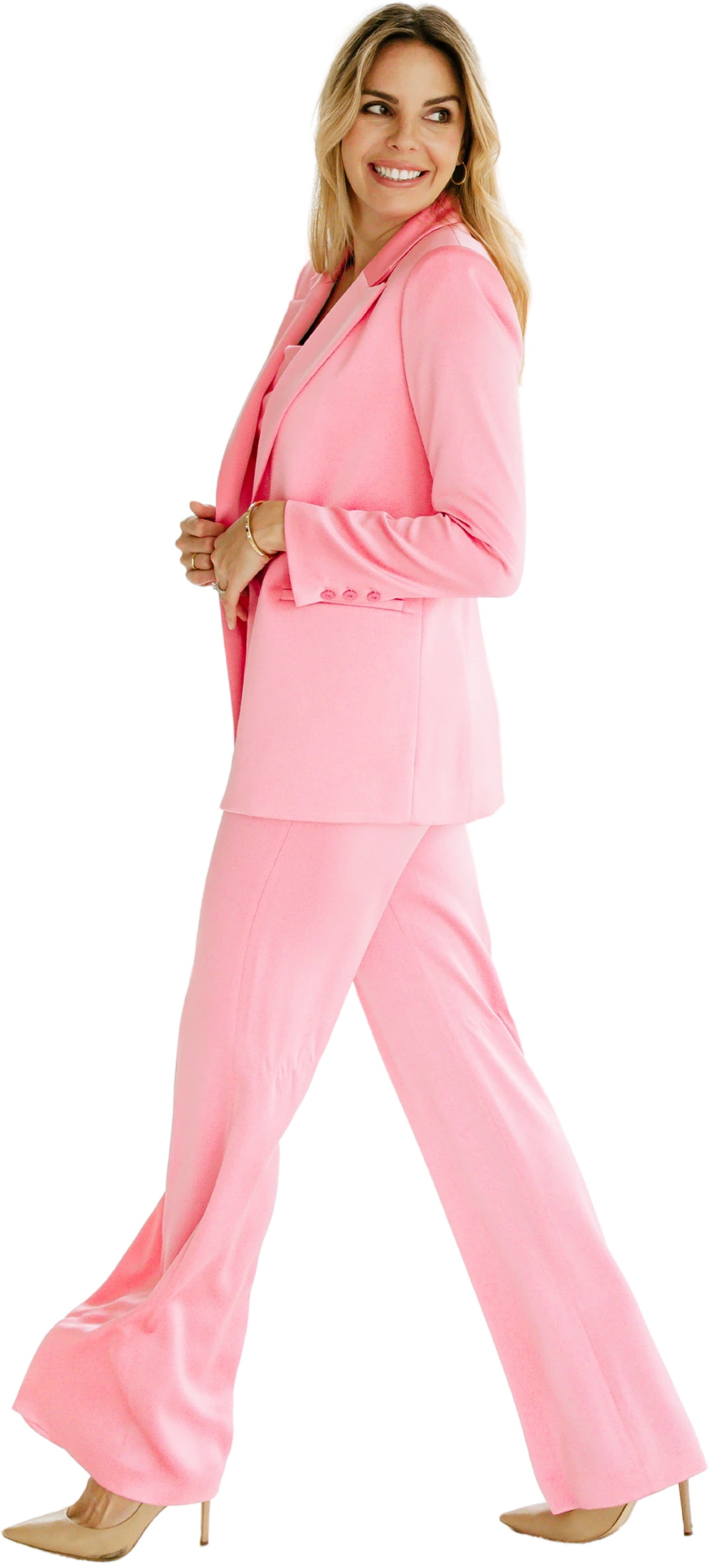 Grace Kaage walking through The Workshoppe in a pink suit